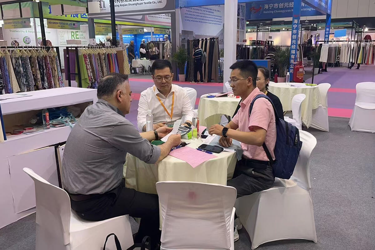 Talking with guests at the exhibition